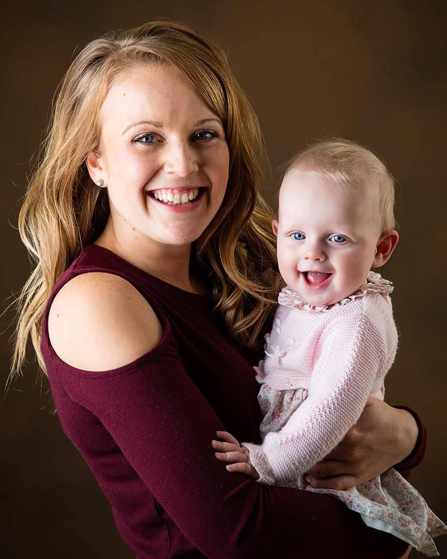Mother and Baby in photography studio in front of brown background