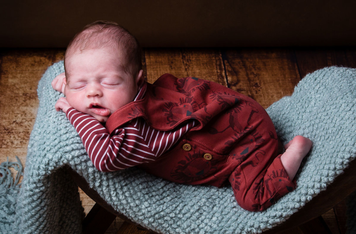 Newborn baby sleeping in photography studio